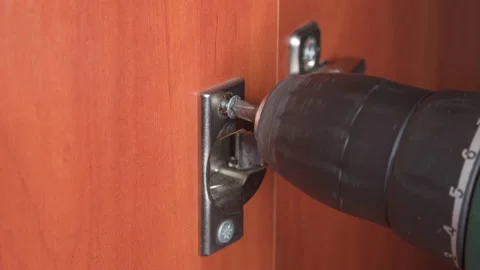 Tightening a screw with an electric screwdriver, assembling furniture, clos.. Stock Footage 225664761