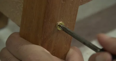 Tightening screw with thread on wood using hand key	 Stock Footage 157660283