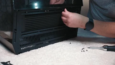 Tightening screws while installing radiator into computer case Stock Footage 325803186