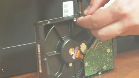 Tightens the screw onto the hard drive. computer assembly Stock Footage 143274905