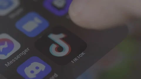Tik Tok icon typing and scroll. Close up shot of hand on social network. Macro Stock Footage