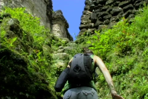 Tikal girl climbing stones Stock Footage