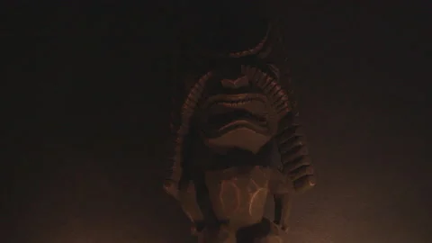 Tiki statue lit by flickering light 2 Stock Footage 130827852