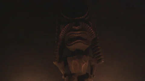 Tiki statue lit by flickering light Stock Footage 130829054