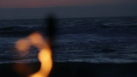 A Tiki Torch with FIRE Blowing in the Wind at the BEACH, (HD 24p) Stock Footage 154208259