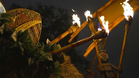 Tiki torches tiki gods Polynesian luau Stock Footage