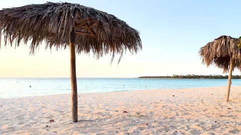 Tiki umbrella on a beach Stock Footage 285432574