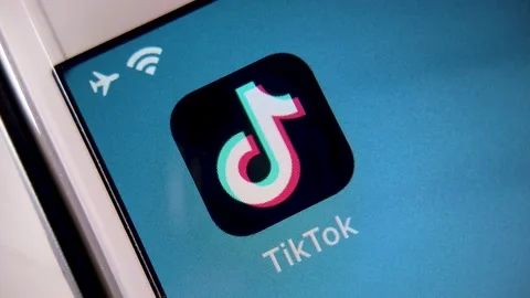 TikTok on iPhone screen from vertical high angle spinning shot. Video stock 139572607