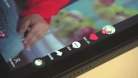 Like on tiktok on tablet. Tapping on the tablet display. Put a heart. Ukraine Stock Footage 229777901
