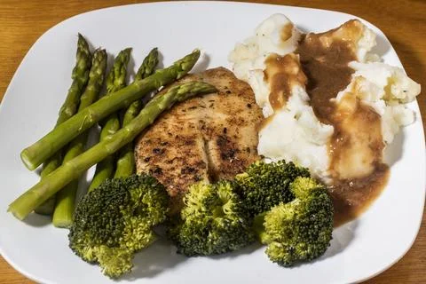 Tilapia  served with  mashed potatoes and vegetables Stock Photos
