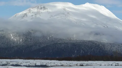 Tild Blue Sky, Clouds, to Snow Covered Mountain, Trees, and Frozen River Stock Footage 38059951