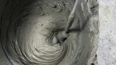Tile adhesive is mixed using an electric drill in a bucket Stock-Footage 153677679