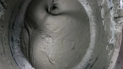 Tile adhesive is mixed using an electric drill in a bucket 스톡 동영상 153677934