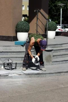 Tile builder worker are cutting the Facing  with a tool Stock Photos