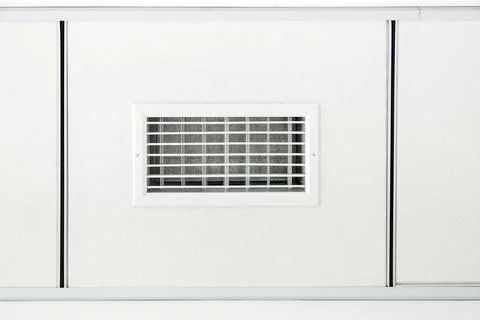 Tile ceiling with square white gypsum tiles with a ventilation grille. Stock Photos