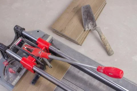Tile cutter with ceramic tiles and ruler. Stock Photos