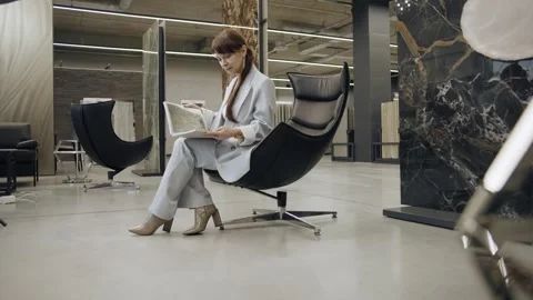 Tile designer browses samples in modern salon Stock Footage 276620199