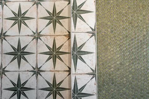 Tile floor with a green star pattern and a green tile border Stock Photos