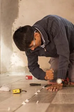Tile floor installer giving the final adjustments. 写真素材