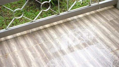 Tile floor wood pattern decor exterior patio house, rainy day scene Stock Footage 93774525