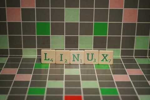 Tile with green linux text on a blocked background Фото