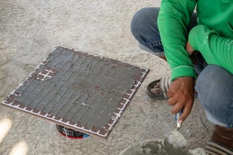 Tile installation process construction site diy tutorial indoor close-up cr.. Stock Photos