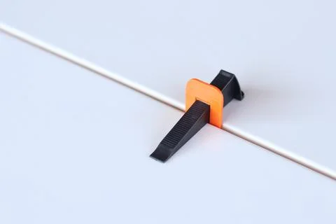 Tile laying process using plastic clamps Stock Photos
