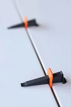 Tile laying process using plastic clamps Stock Photos