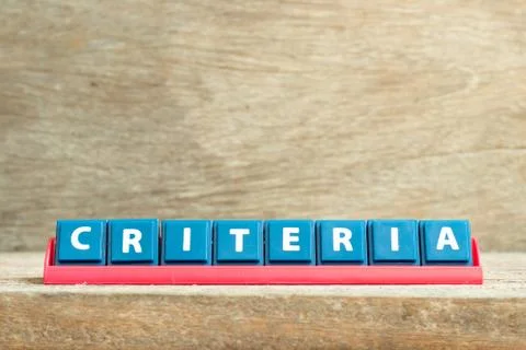Tile letter on red rack in word criteria on wood background Stock Photos