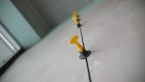 Tile leveling system between ceramic slabs on wall Stock Footage 314058651