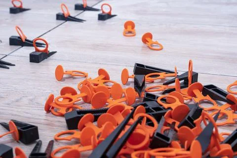 Tile leveling system with plastic clips and wedges. repair school Stock Photos