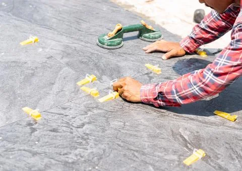 Tile leveling system with plastic clips and wedges. narrow tiles installed .. Stock Photos