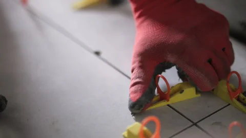 Tile leveling system tool in use on floor tiles Stock Footage 311881080