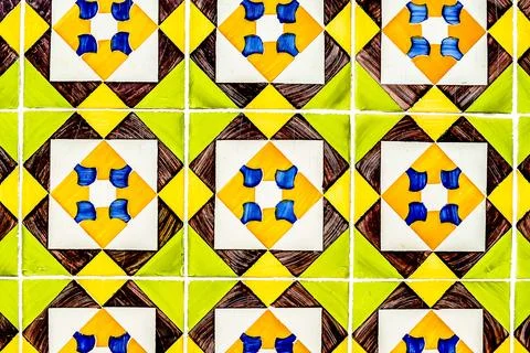 A tile pattern with yellow, green, and white tiles Stock Photos
