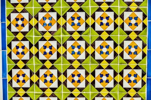 A tile pattern with yellow, green, and blue tiles Stock Photos
