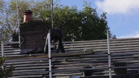 Tile roof repairs workman roofer Stock Footage 74692468