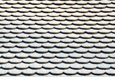 Tile roof in the snow. Winter background Stock Photos