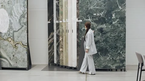 Tile salon designer browsing marble samples Stock Footage 276620611