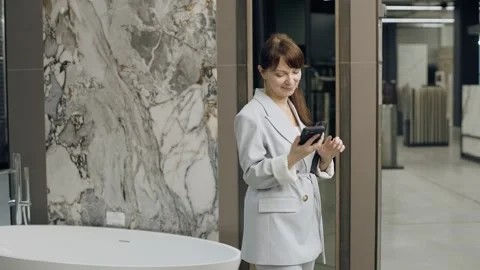 Tile salon designer discusses project with client on phone Stock Footage 276620454