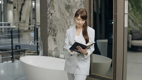 Tile salon designer reviews samples and writes in a notebook Stock Footage 276620391