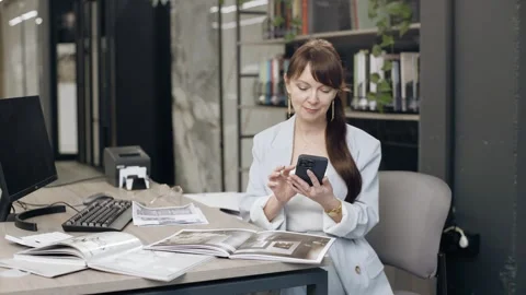 Tile salon designer reviews samples at the table Stock Footage 276620768