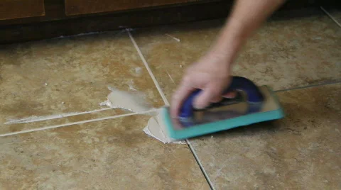 Tile setter grouting Stock Footage