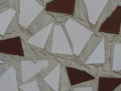 Tile triangles in concrete plaster on the wall Foto stock