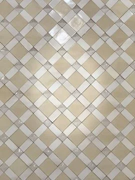 Tile wall background with diamond pattern in neutral tones creating a geome.. 스톡 사진