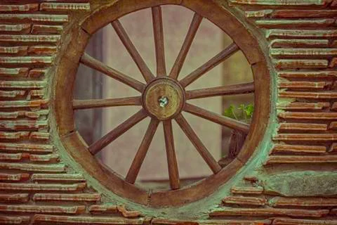 Tile wall with wheel on the wagon Stock Photos