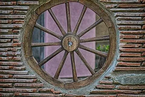 Tile wall with wheel on the wagon Stock Photos