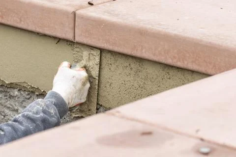 Tile Worker Applying Cement with Trowel at Pool Construction Site. Stock Photos