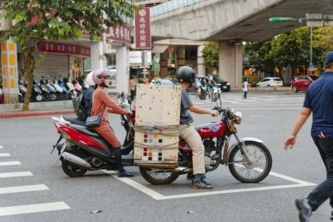 Tile Worker Carrying Samples on Motorcycle in Taipei Traffic 스톡 사진