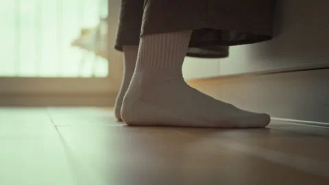 On a tiled kitchen floor near the balcony doors a housewife-still a girl at Stock Footage 332481196