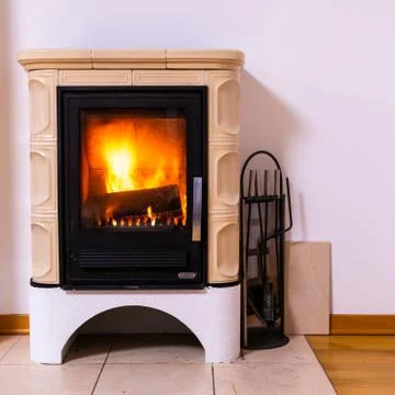 Tiled stove with fire burning inside Stock Photos